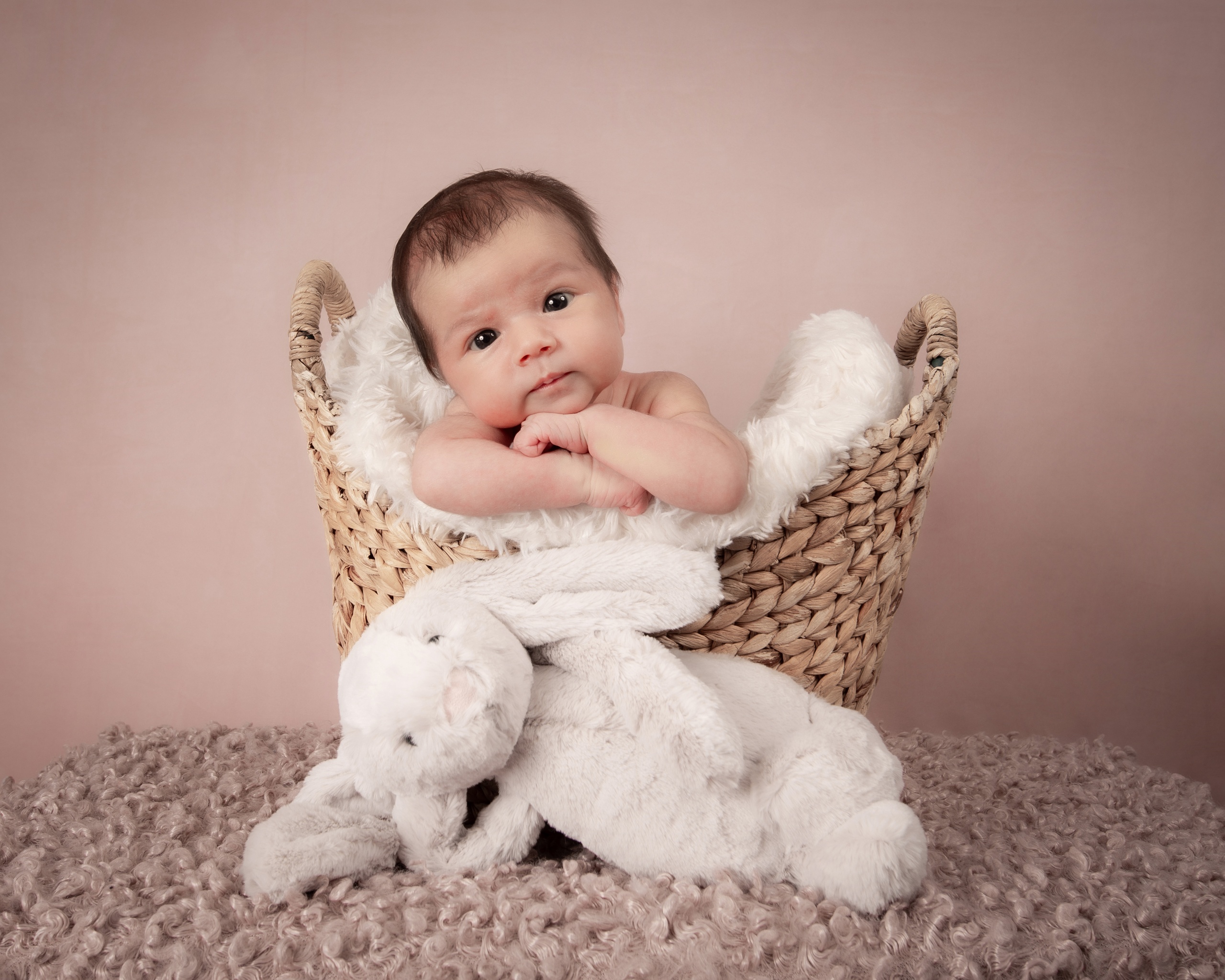 Baby portrait in a woven basket