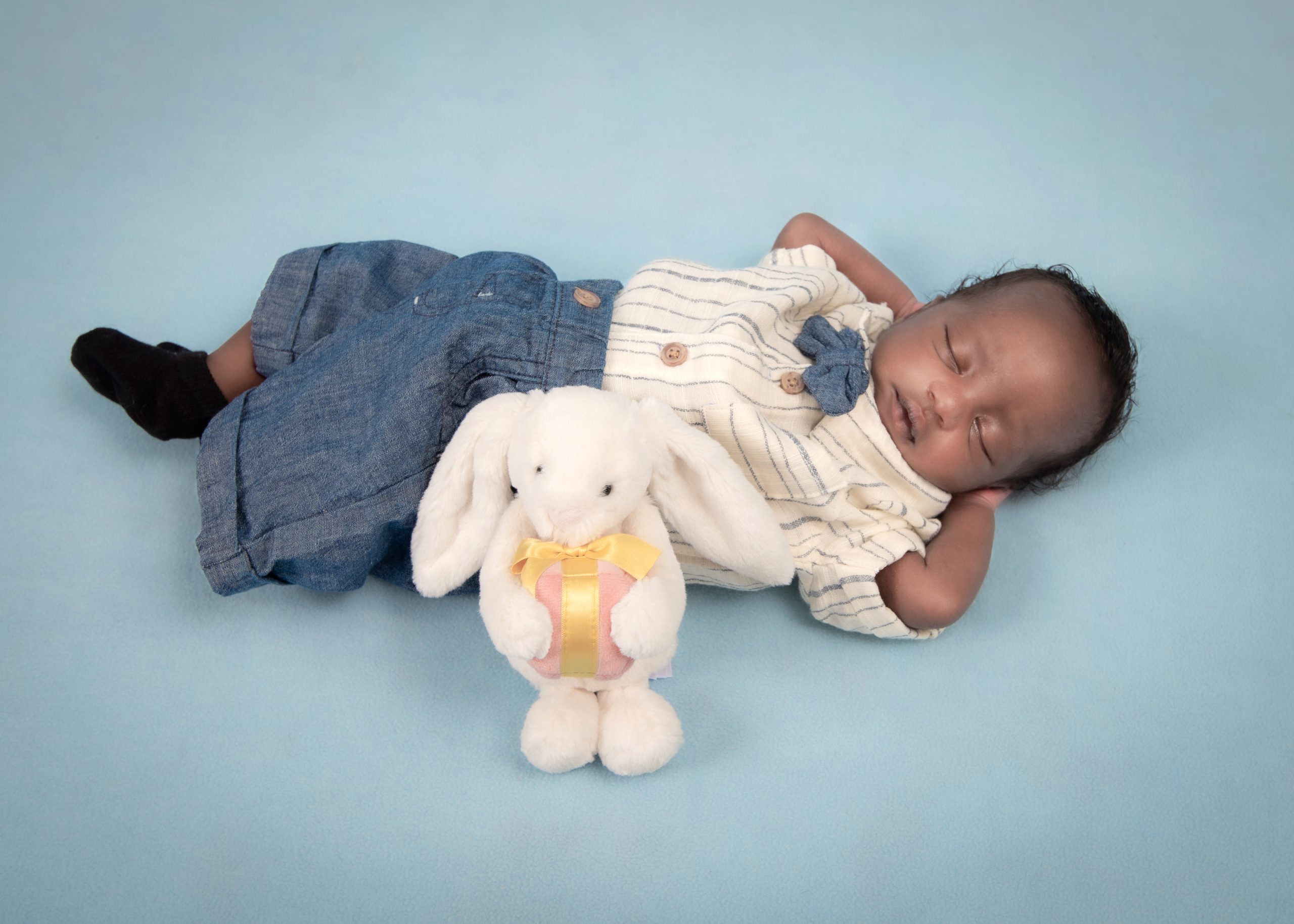 Sleeping newborn baby portrait with a bunny