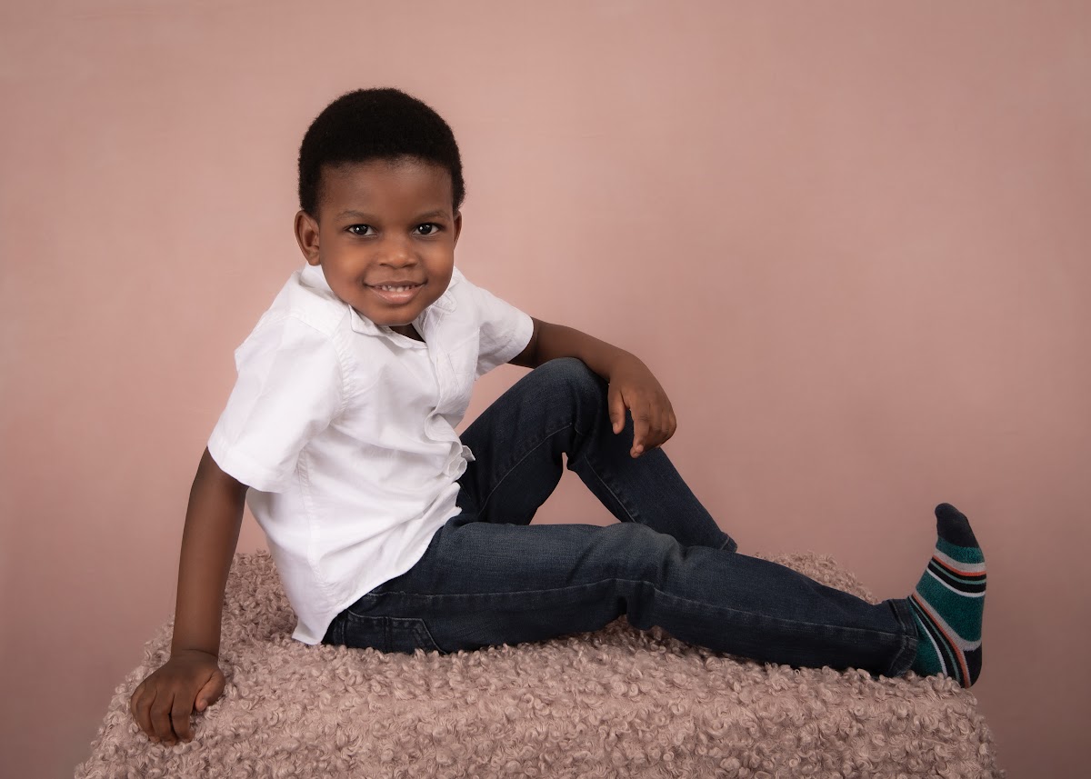 Daycare child portrait on a pink backdrop