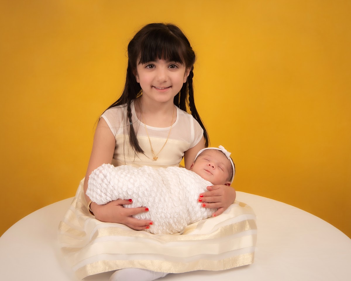 Daycare sibling portrait on a yellow backdrop