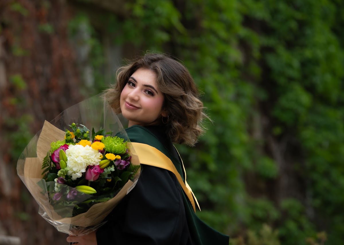 Outdoor graduate portrait with a bouquet