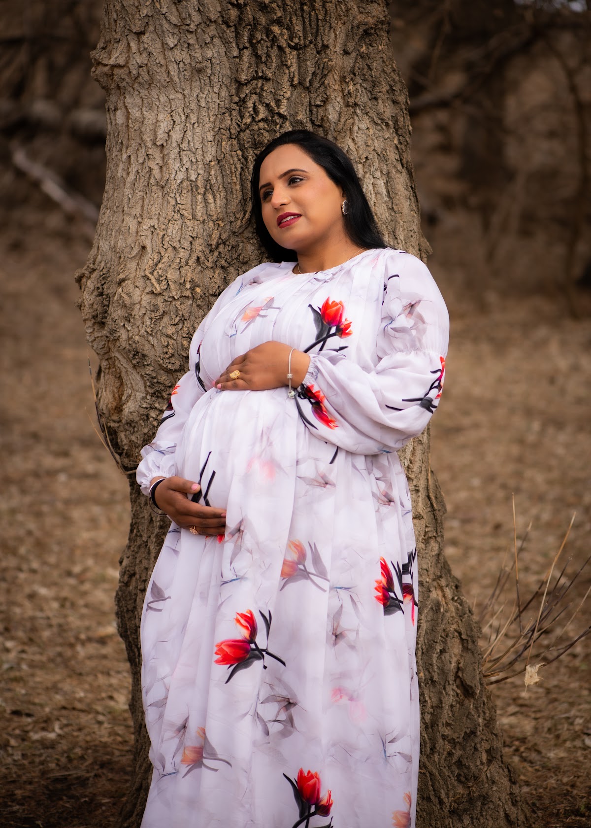 Outdoor maternity portrait in a white floral dress