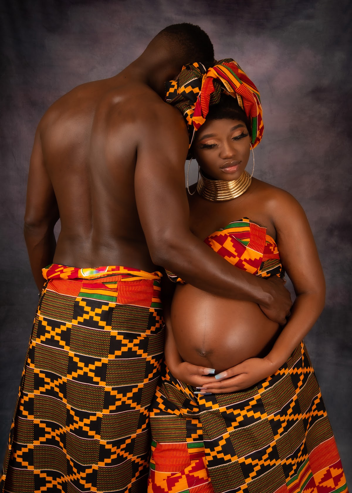 Couple maternity portrait in coordinated outfits